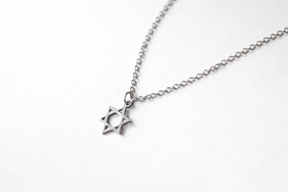 Silver necklace with a star pendant on a white background